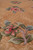 Raised floral sprays in pink, green and blue rising above the sculpted beige field