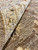 Pile folded back to show dense wool knotting and the cotton foundation of this rug