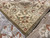 Flipped corner revealing the woven back, ivory selvage and fringe of the 6x13 rug