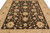 Field close-up of the 8'2" x 9'9" wool rug: cream palmettes, sage leaves, peach flower centers