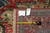 Reverse of the rug with Made in India hand-knotted tags and tape measure