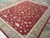 Angled view along the rug showing pile sheen and the taupe border running away