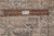Reverse of the rug with a twelve inch ruler marked Authentic Hand Made across the weave