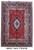 Full overhead view of the red Tabriz rug with ivory medallion and dark navy floral border