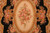 Close detail of the central oval panel with a pink rose bouquet on ivory ground