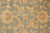 Close detail of the field showing large gold palmettes with rust outlines on sage ground