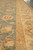 Field meeting the gold main border and its narrow guard stripes, seen at an angle