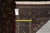 Back of the rug with tape measure and a tag marked 6-1 by 8-10