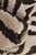Pile gathered in folds, showing chunky cream and dark brown wool knots in close view