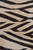 Tight detail of the field, dark forked strokes and pointed bands over taupe wool knots