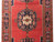 Middle section of the rug, medallion centred between both navy side borders and red field