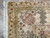 Corner detail with ivory fringe, border bouquets and the sage leaf cartouche beside it