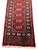 One end of the runner with its lattice panel, beaded guard stripes and clean ivory fringe
