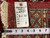 Dealer tag marked rug no. 6780 and size 2.1 x 26 beside a tape measure