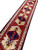Runner viewed lengthways from one end, medallions and borders shrinking away into the distance