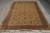 Full rug laid lengthwise on grey plank flooring with fringes at both narrow ends