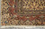 Corner detail with boteh in the ivory outer band and fringe below on tile