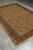 Full rug photographed diagonally on tile flooring, showing the all-over field and border frame