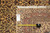 Back of the rug with the dealer tag reading 6.5 x 9.6 and a tape measure