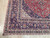 Corner detail showing the three border bands, spandrel ivory panel and the white fringe edge
