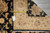 Tape measure and the seller's tag B-79592 laid across the ivory border of the rug