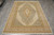 Overhead shot of the whole rug on grey tile flooring with fringe at the lower edge