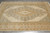 Angled overhead view showing the medallion and the wide camel scroll border along one side