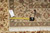 Tape measure and handwritten inventory tag laid on the border near the fringed end