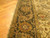 Close view of the border corner showing linked palmette cartouches and narrow flowered guard stripes