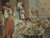 Close view of seated turbaned men reaching toward dishes of grapes, melon, peaches and figs