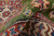 Pile rolled back to show green wool depth against the ivory and red border beneath