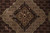 Tight detail of the dark centre medallion with four-petal flower and pale sage outlines