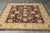 Angled full view on grey tile, all-over floral field framed by pale gold border