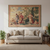Tapestry hung on a pale wall above a cream sofa with cushions, lamp and plants