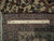 Reverse of the rug folded back beside a twelve inch ruler, showing border knotting