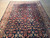 Rug photographed from one short end, fringe at top, pattern receding down the length