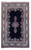 Full rug flat on white, navy field, ivory script border, ivory fringe at both ends