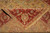 Corner folded back to show the knotted reverse, border palmettes and plain gold fringe