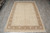 Rug laid flat on grey tile floor, whole floral field and border visible from above