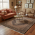 Rug on wood floor in a room with rust sofa, armchairs and round brass coffee table