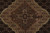 Macro of the rose-brown floral medallion core with slate blue and sage leafwork