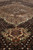 Raking view across the pile toward the medallion, ivory pendant and lattice in sharp focus
