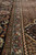 Border bands at close range, slate guard stripe beside the black palmette and leaf border
