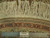 Reverse of the rug with knotted ivory warp fringe, ruler and Authentic Hand Knotted label