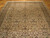 Angled view along the rug showing the all-over palmette repeat and the brown main border