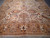 End section of the rug with mirrored central palmette above the wide honey end border