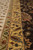 Diagonal close-up of the gold inner border, olive guard stripe and pale main band