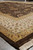 Low angle along a corner, cream and gold borders rising toward the dark field behind