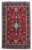 Full overhead view of red Tabriz rug with navy central medallion and ivory and indigo double border