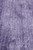 Macro detail of the dense low wool pile in mottled violet and silver
